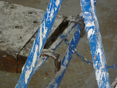Blue ladder covered with paint