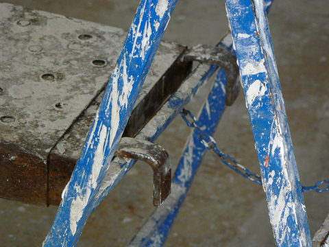 Construction ladder covered with paint
